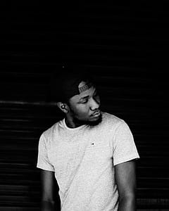Grayscale Photo of Man Wearing Snapback Cap thumbnail