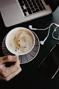 Male working with a laptop and a cup of coffee thumbnail