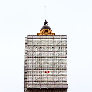 gray and brown high-rise building under white sky thumbnail