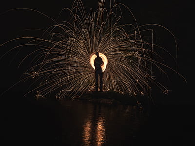 steel wool photo of person beside body of wter thumbnail