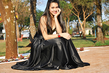 woman wearing black silk sleeveless dress thumbnail