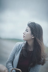 selective focus photography of woman wearing gray cardigan thumbnail