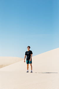man standing on white desert under blue sky thumbnail