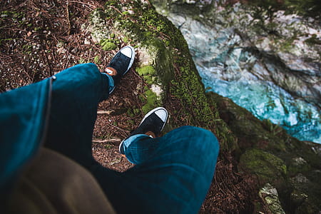 Stepping close to the edge of a rock with waterfall in the background thumbnail
