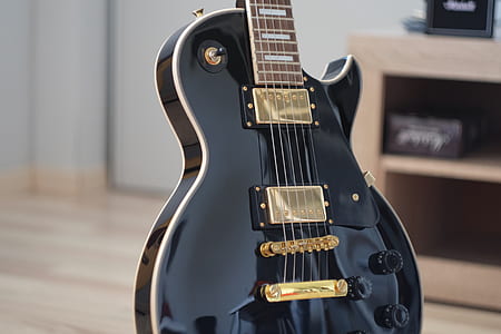 selective focus photography of black electric guitar thumbnail