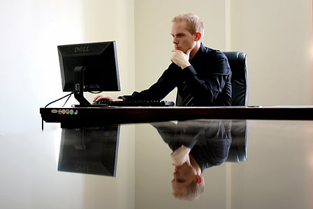 man looking at computer monitor thumbnail