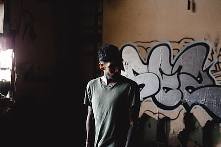 man standing near brown painted wall thumbnail