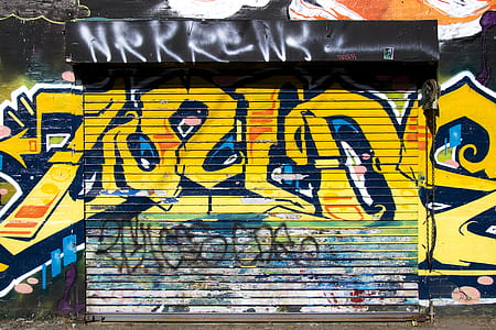 yellow and black graffiti wall art at daytime thumbnail