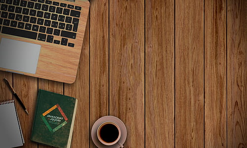 white ceramic cup beside green book thumbnail