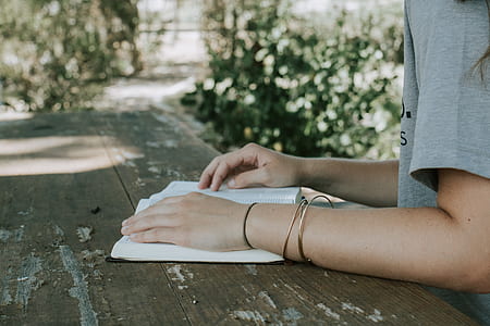 person reading book during daytime thumbnail