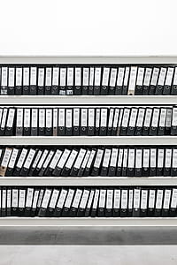 white wooden bookcase with binders thumbnail