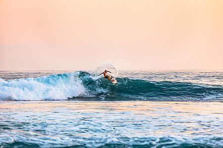 man surfing during daytime photo thumbnail