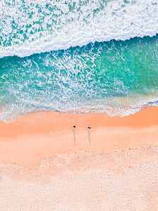 low-angle photography of two person at beach side thumbnail