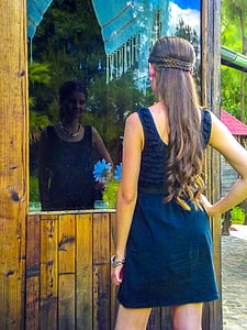 woman standing in front of brown wooden booth during daytime thumbnail
