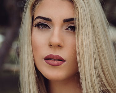 selective focus photography of blonde-haired woman with makeup thumbnail
