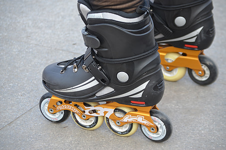 person wearing black-and-orange inline skates thumbnail