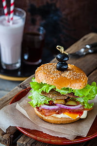 hamburger on round red ceramic plate thumbnail