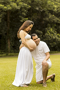 man leaning on woman's tummies thumbnail