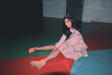 woman sitting on red and gray flooring thumbnail