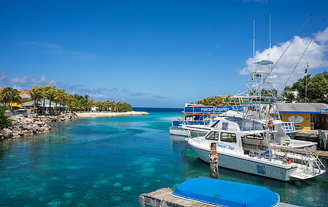 white motorboat dock on port during daytime thumbnail