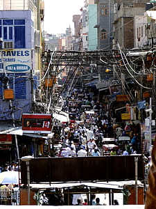 people in road between houses during daytime thumbnail