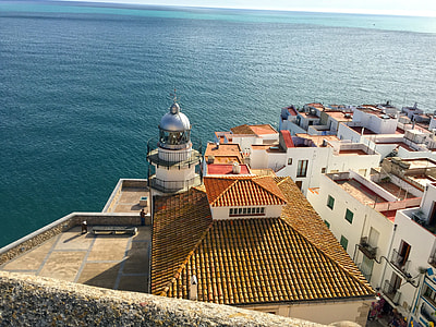 aerial photo of white concrete lighthouse near body of water at daytime thumbnail