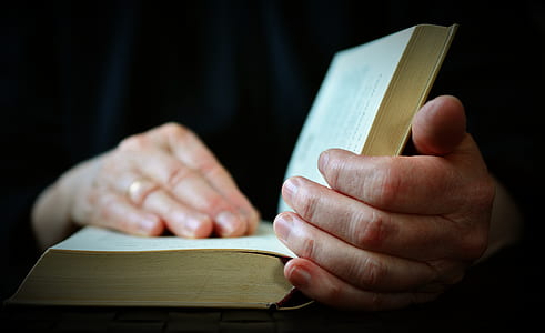 person opening book thumbnail