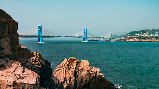 blue and white bridge under white sky thumbnail