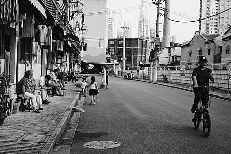 grayscale photo of man riding on bicycle thumbnail