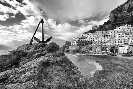 grayscale photography of anchor on top of rock formation thumbnail
