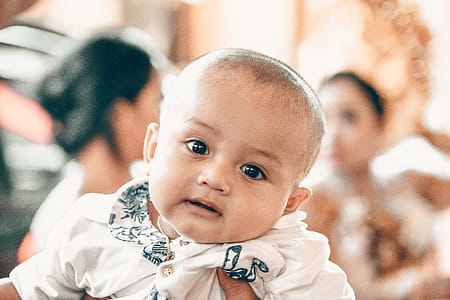 Baby in White Top in Tilt Shift Lens Shot thumbnail