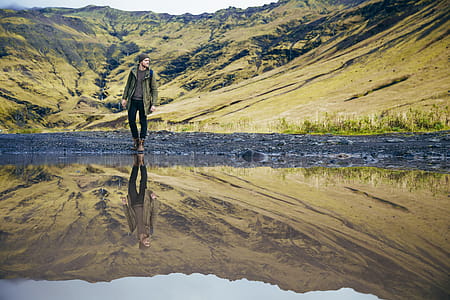 A young caucasian hiker s reflection in the lake thumbnail