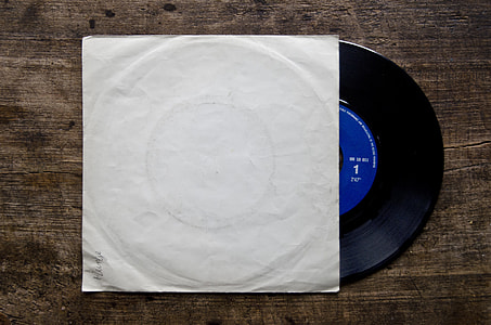 black and blue vinyl record on brown wooden top thumbnail