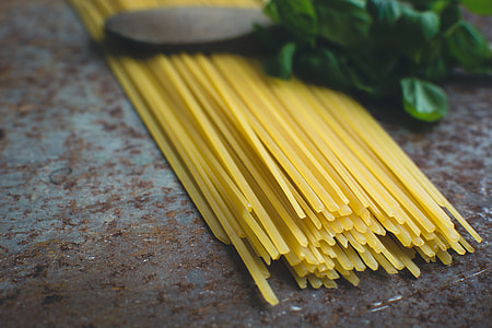 Pasta spaghetti with basil and a wooden spoon thumbnail