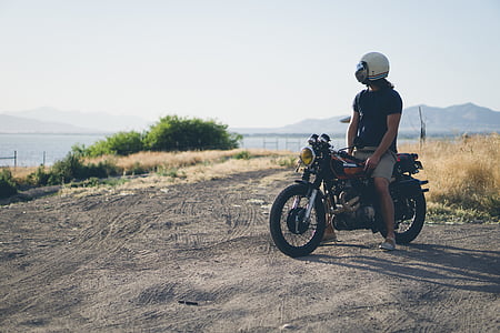 person sitting on black motorcycle thumbnail