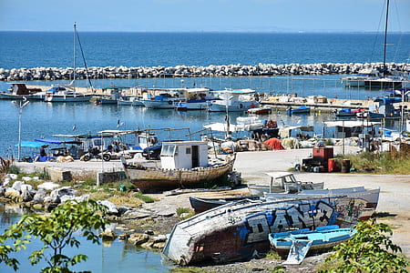several boats dock beside seawall thumbnail