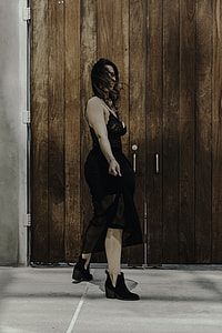 woman standing beside wooden doors thumbnail