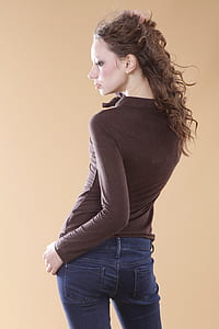 photograph of woman in brown sweat shirt and blue denim jeans thumbnail