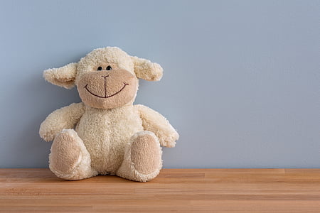 white sheep plush toy on brown wood flooring thumbnail