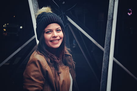 woman wearing black and brown bobble hat thumbnail