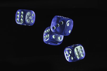 four blue dice against black background thumbnail