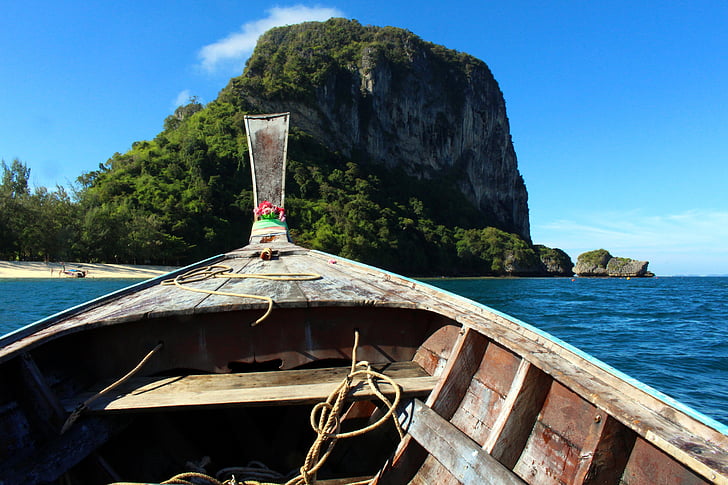 brown canoe boat on ocean