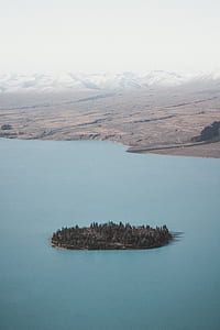 island surrounded with water at daytime thumbnail