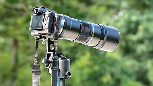 black DSLR camera with telephoto lens thumbnail