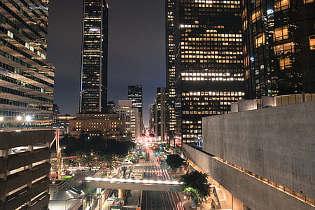 city buildings during nighttime in time lapse photography thumbnail