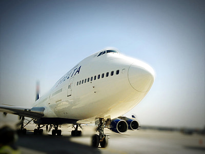 tilt shift photography of white airplane thumbnail