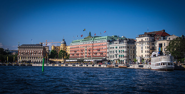 white yacht beside building thumbnail