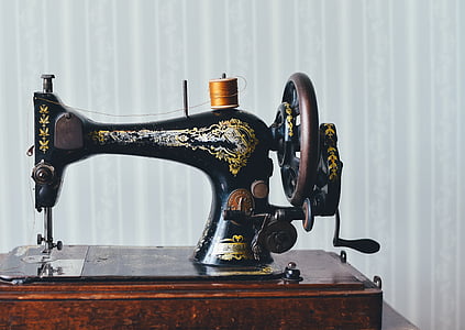 black treadle sewing machine with brown spool on top thumbnail