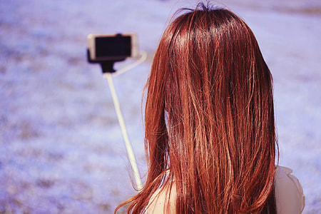 depth of field photography of woman taking photo thumbnail