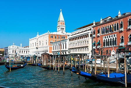 white and brown buildings beside body of water thumbnail